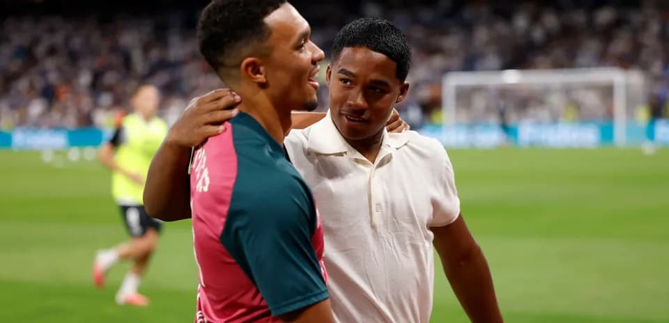 Two players embracing on the field post-match