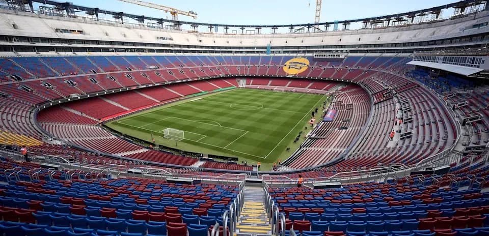 View of empty stadium with football pitch and seating