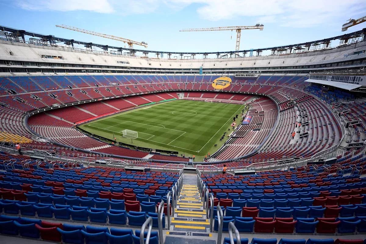 View of empty stadium with football pitch and seating