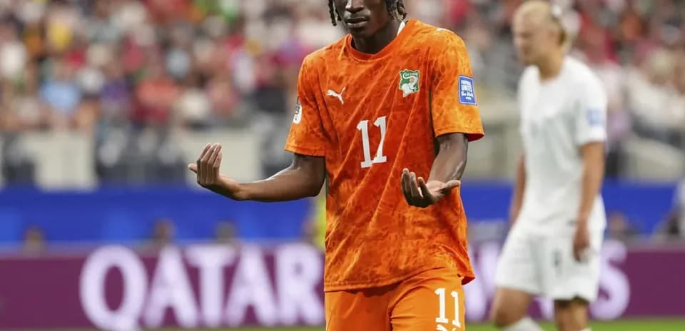 Player in orange jersey gesturing during match
