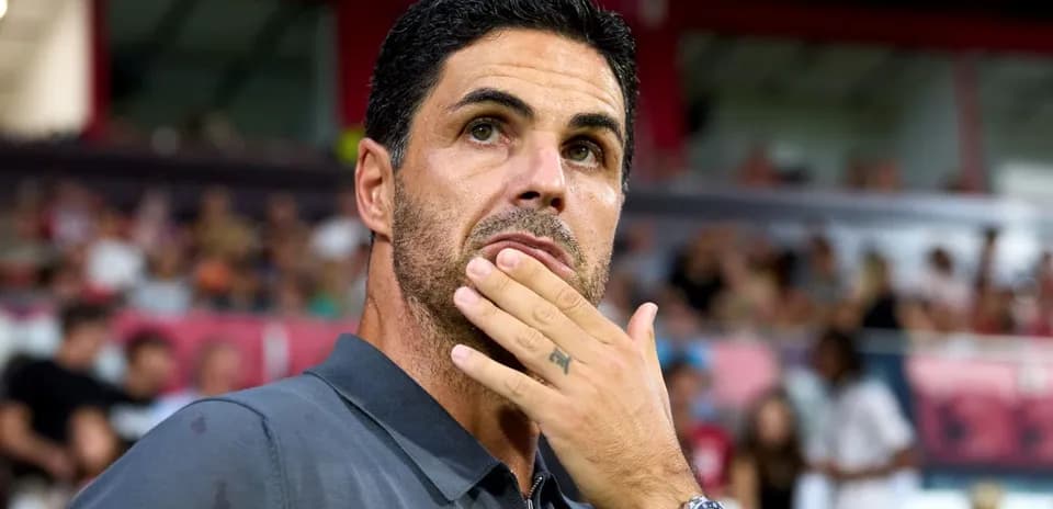 Coach observing the game with thoughtful expression