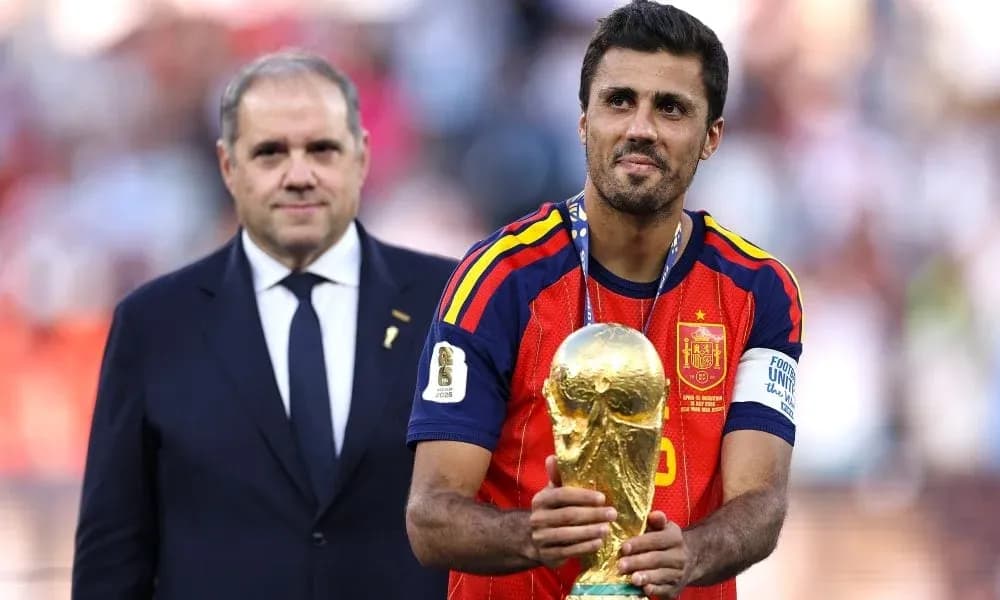 Player holding World Cup trophy on podium