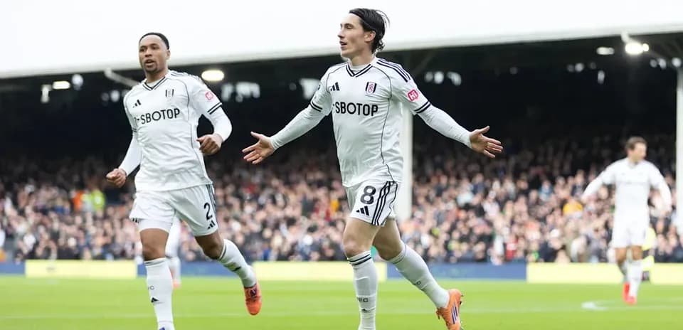Fulham players celebrating a goal on the pitch