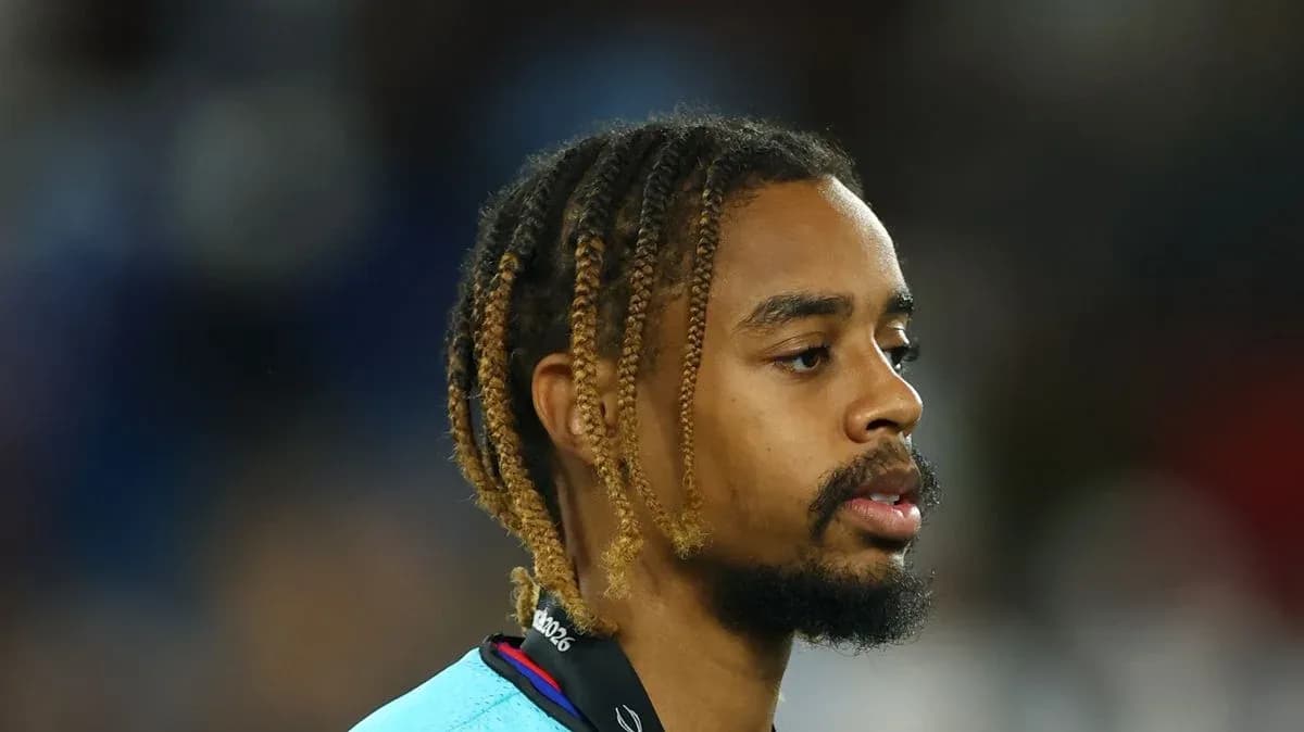 Player with braided hair wearing a team jersey