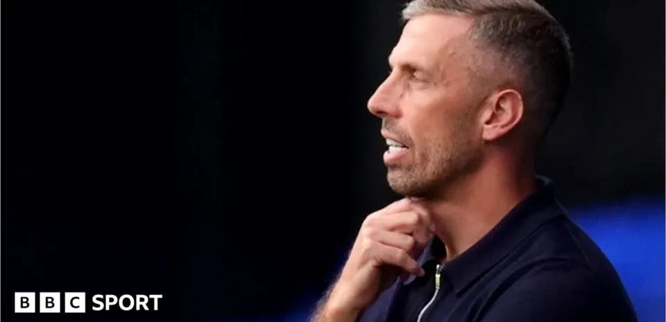 Coach pondering during a match on the sidelines