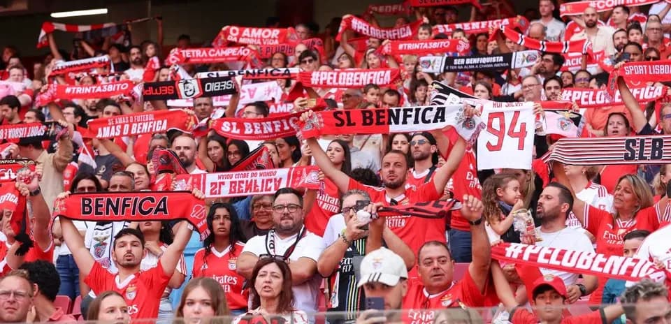 Benfica fans cheering with scarves in stadium