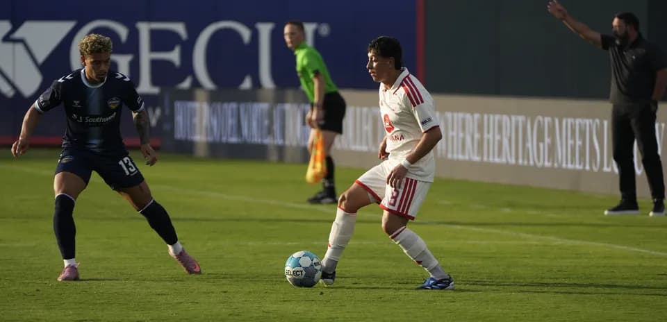 Players competing for the ball during match