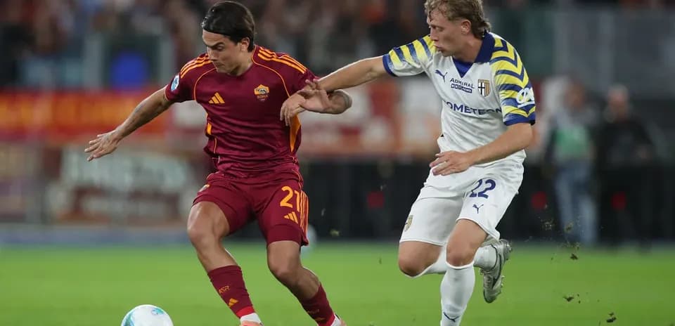 Player from AS Roma battling Parma player for ball