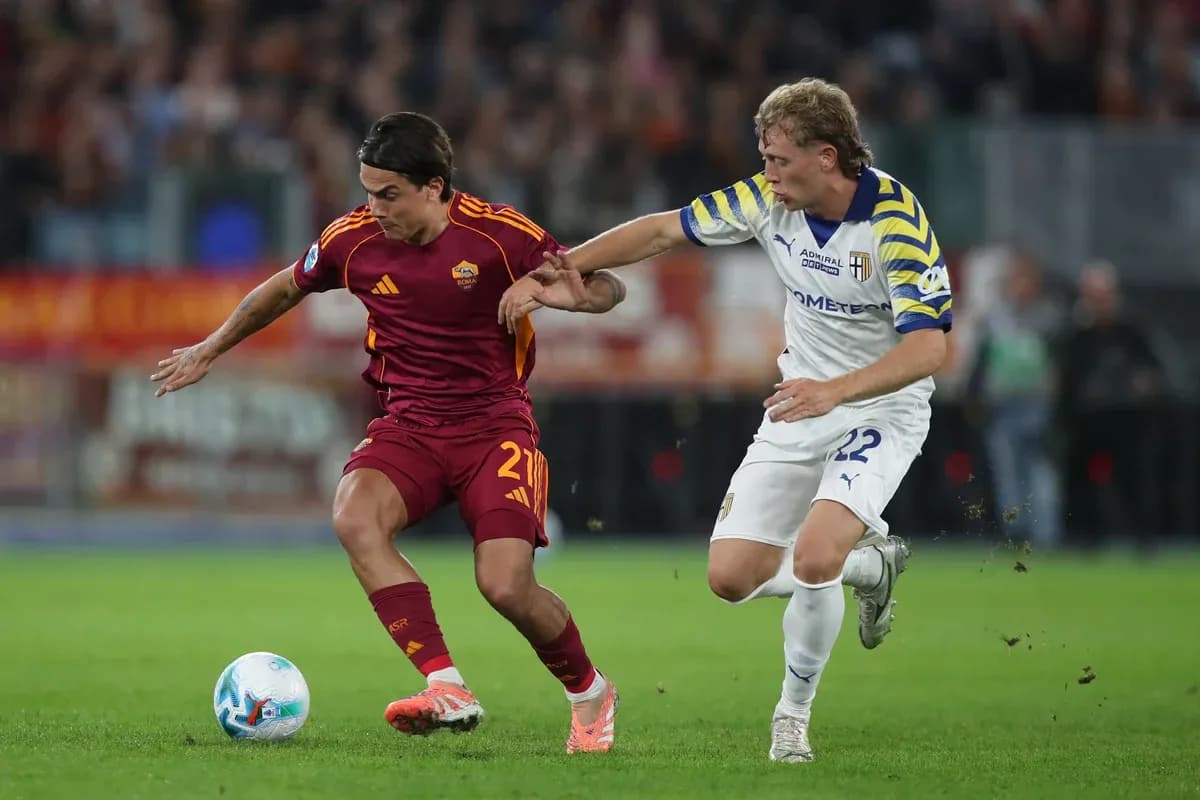 Player from AS Roma battling Parma player for ball