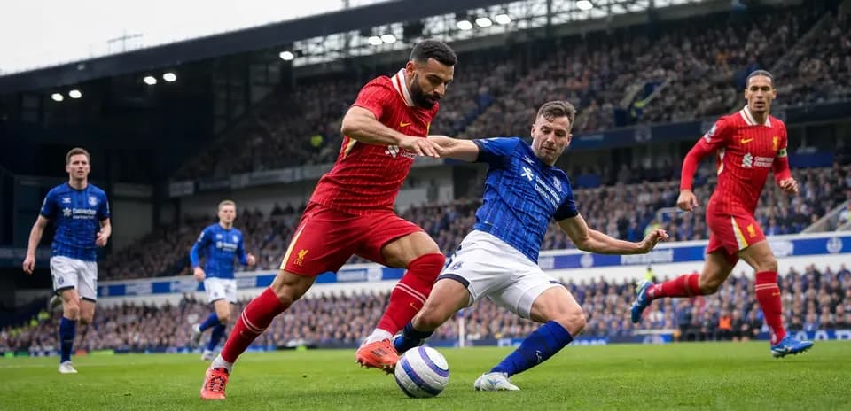 Player tackling opponent during Liverpool vs Everton match