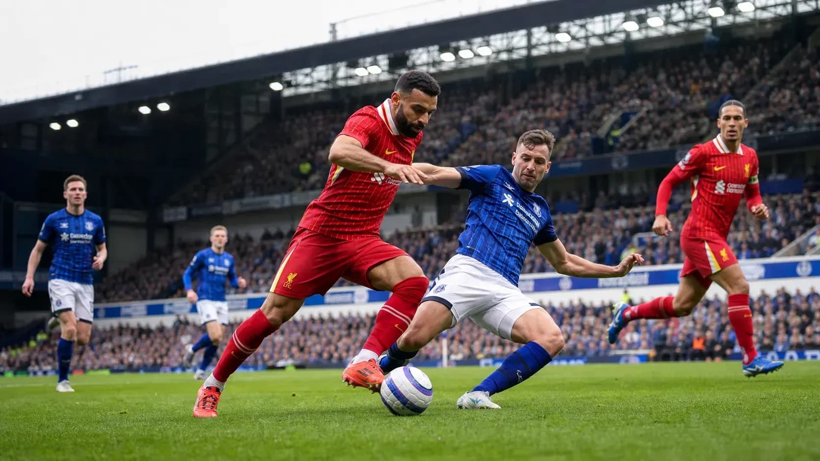 Player tackling opponent during Liverpool vs Everton match