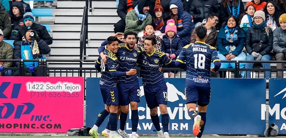 Players celebrating a goal during Colorado Springs match