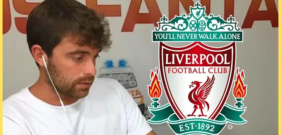 Person with headphones near Liverpool FC logo