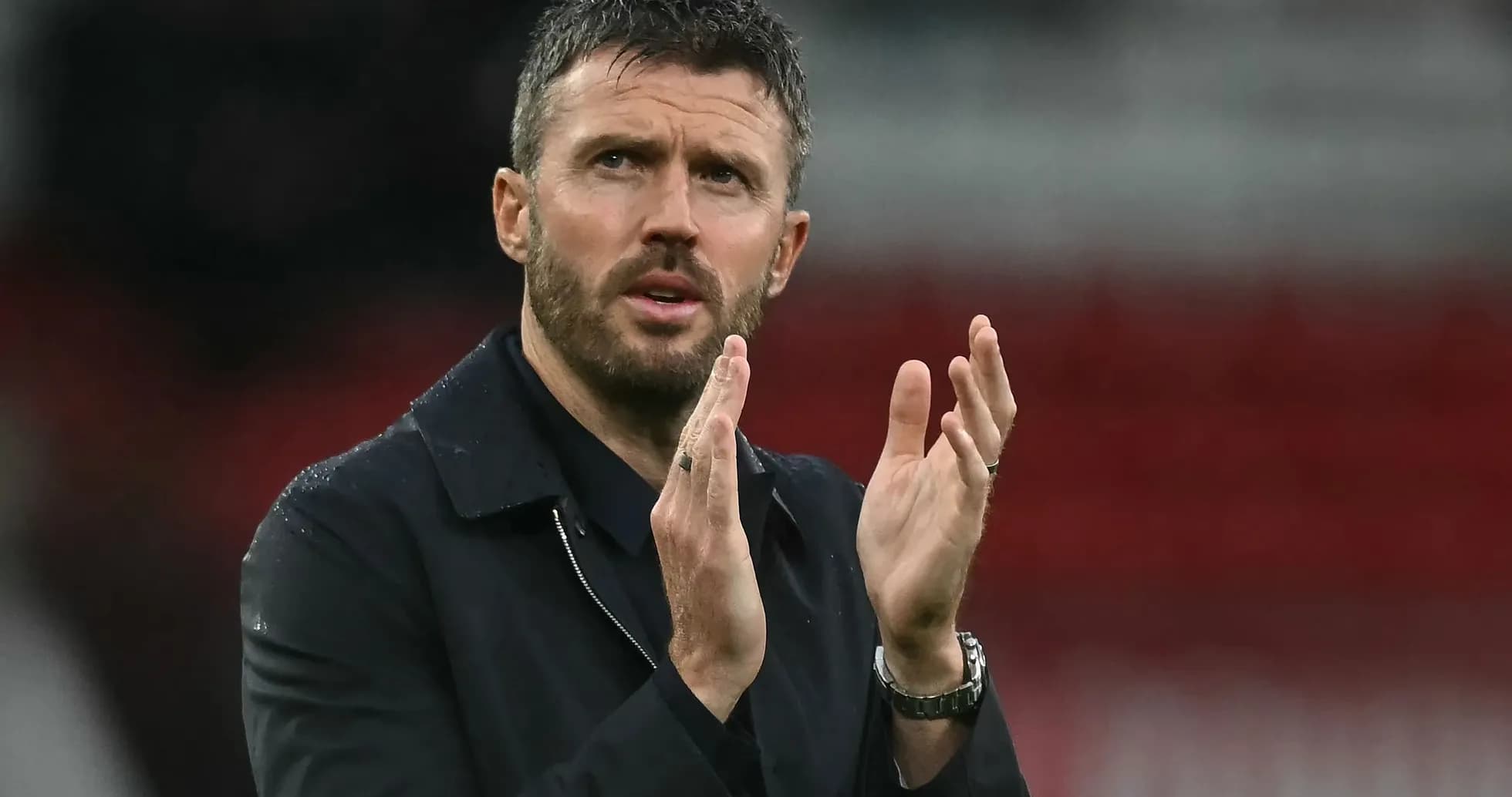 Coach applauding during a match on the sidelines