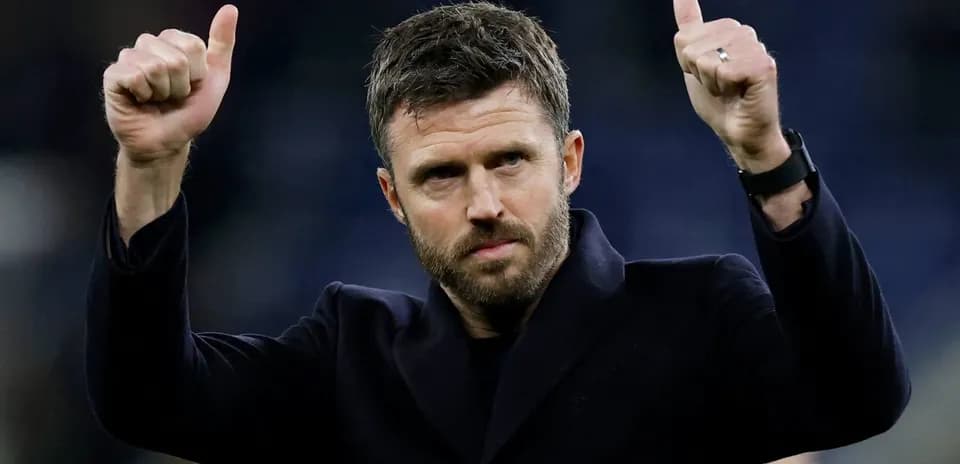 Man giving thumbs up gesture on field