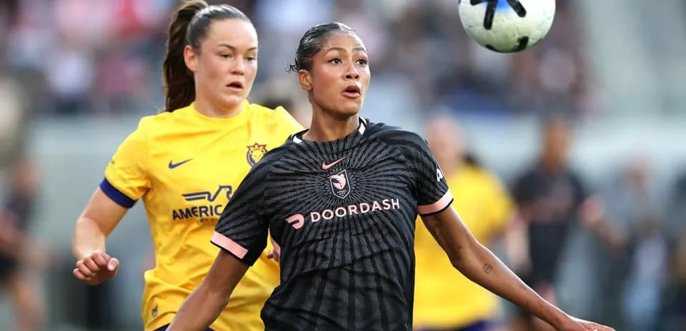 Players competing for the ball during NWSL match