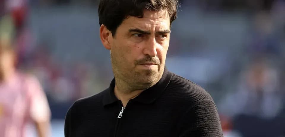 Coach observing players during warm-up on field