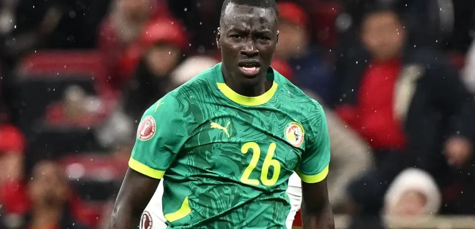 Player in green jersey reacting during football match