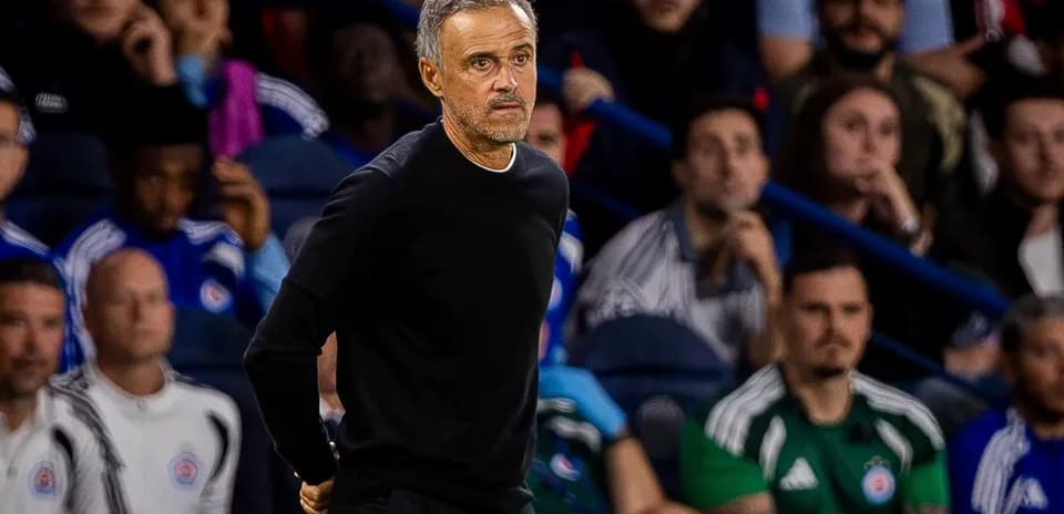 Coach observing from the sidelines during match
