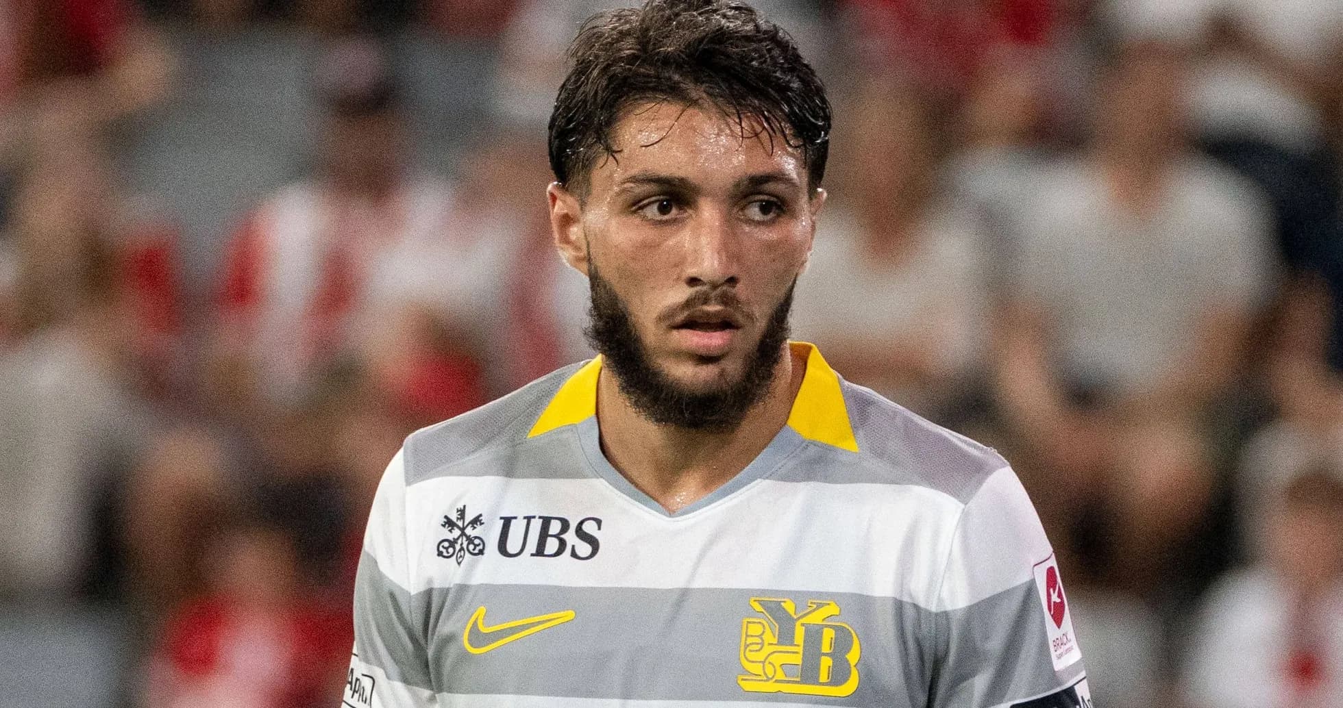 Player in gray and yellow jersey during match