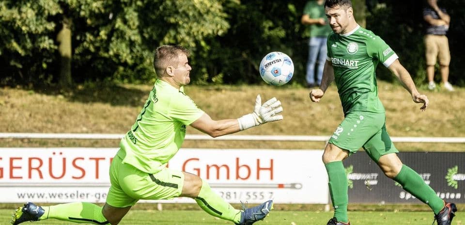 Goalkeeper attempting to save a shot on goal