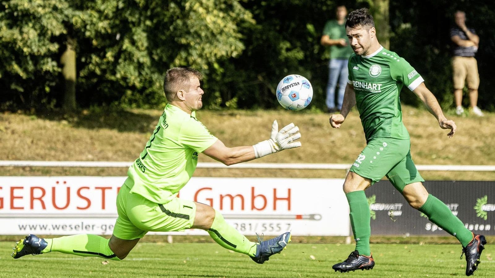 Goalkeeper attempting to save a shot on goal