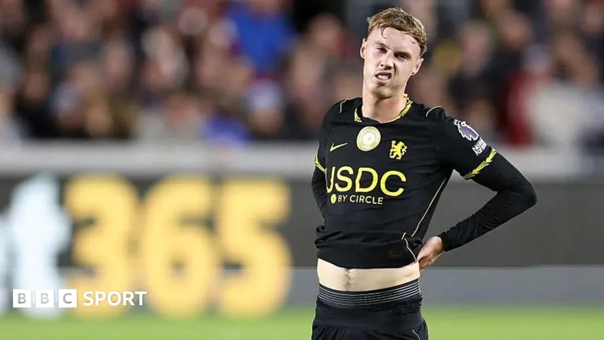 Player in black jersey grimacing during match