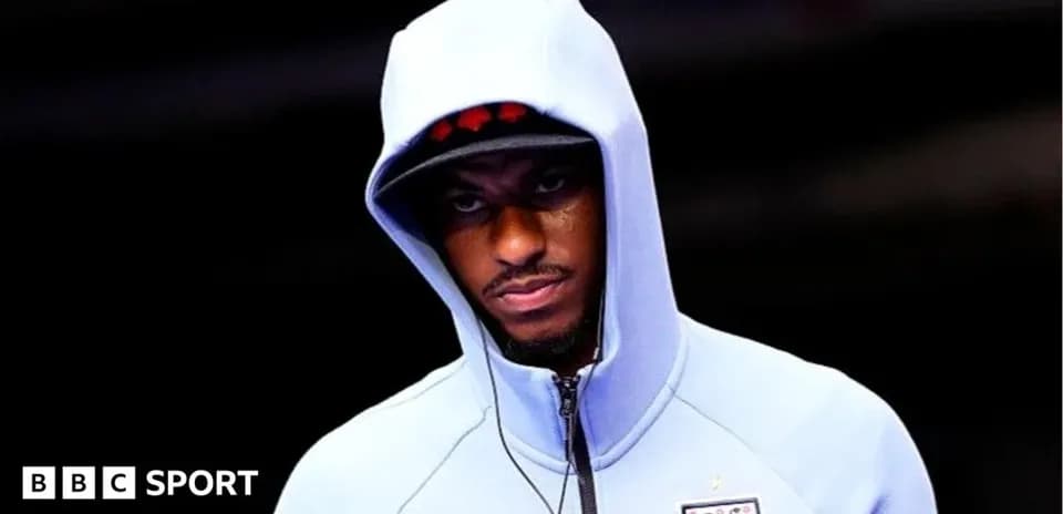 Player in a hooded sweatshirt before a match