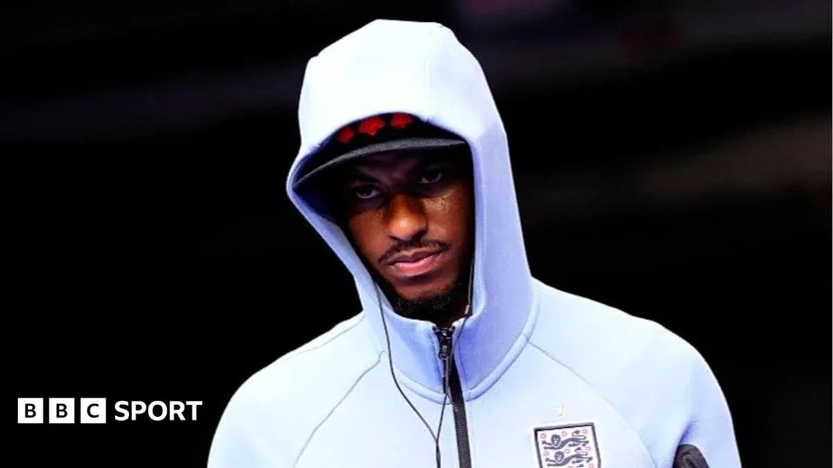 Player in a hooded sweatshirt before a match