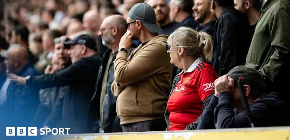 Fans watching a match in the stadium stands