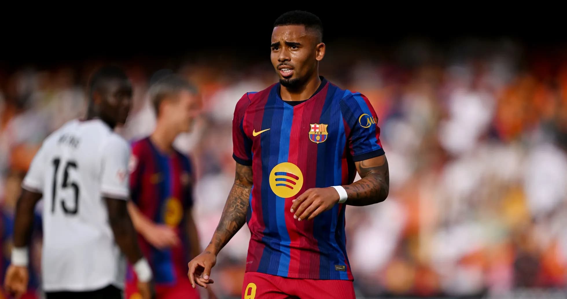 Barcelona player walking on pitch during match