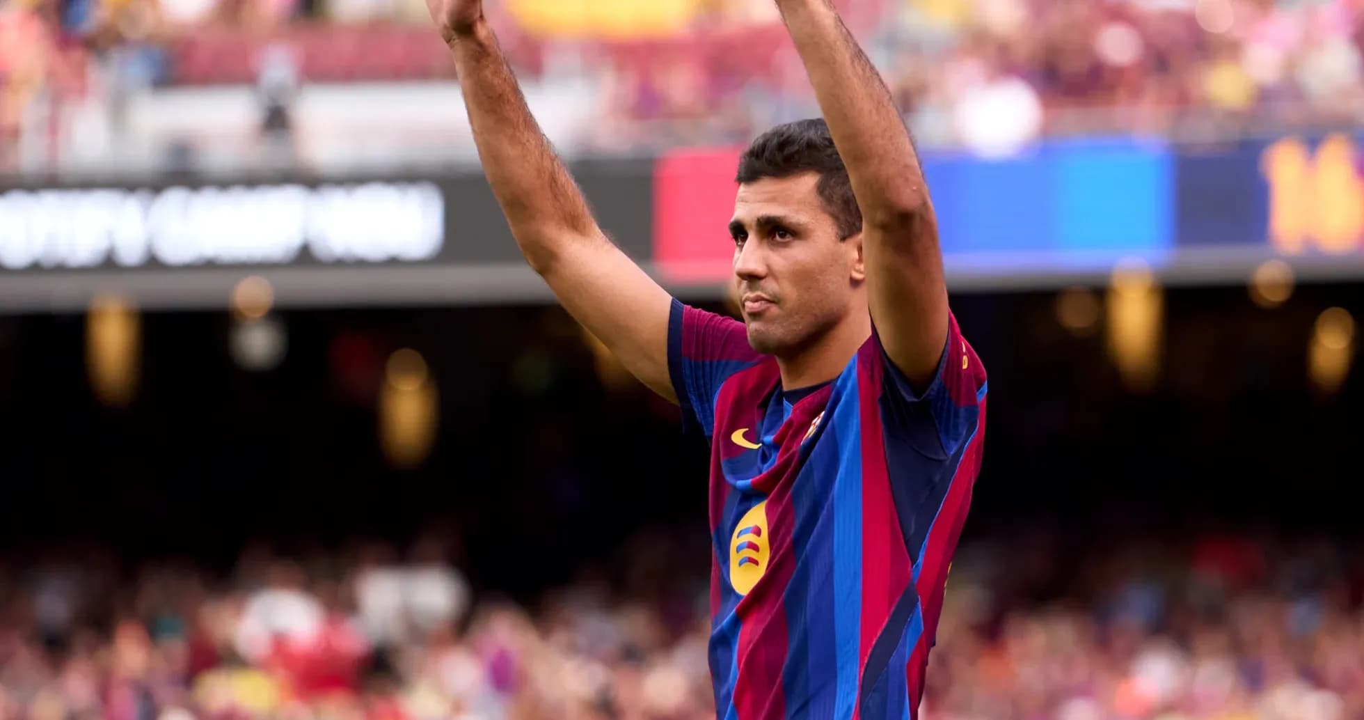 Player celebrating with arms raised at Camp Nou