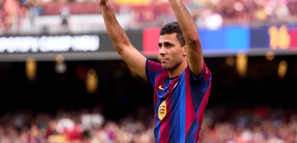 Player celebrating with arms raised at Camp Nou