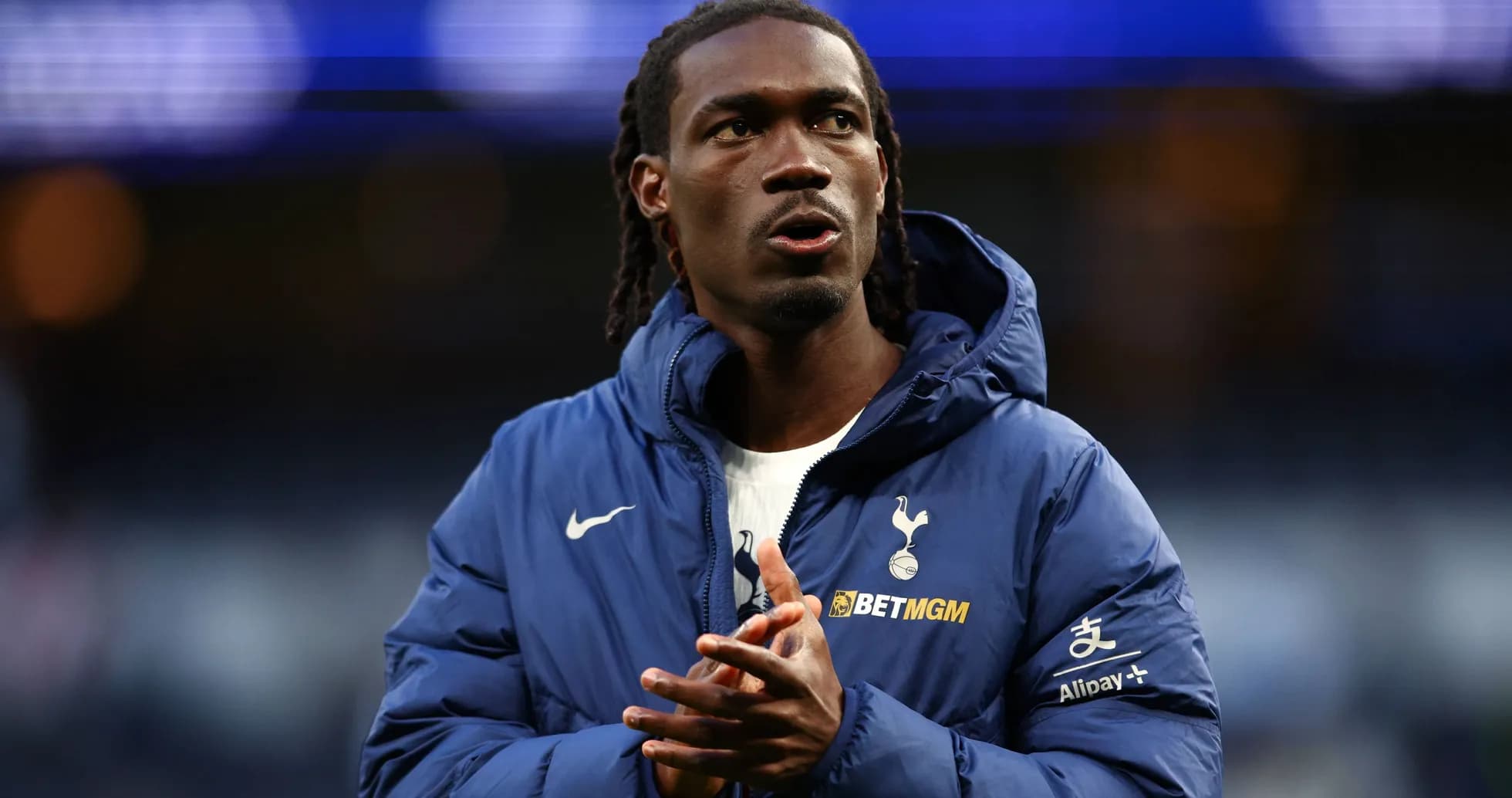 Player in Tottenham jacket clapping before match