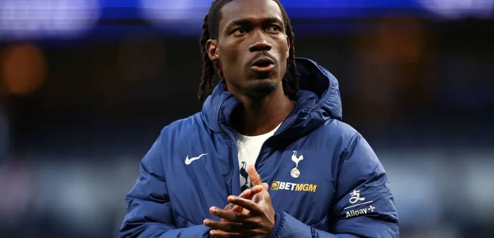 Player in Tottenham jacket clapping before match