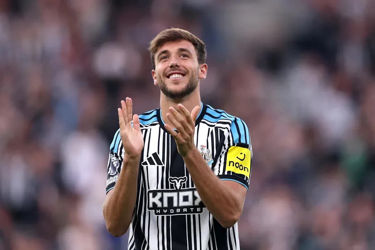 Player applauding fans wearing Newcastle United jersey