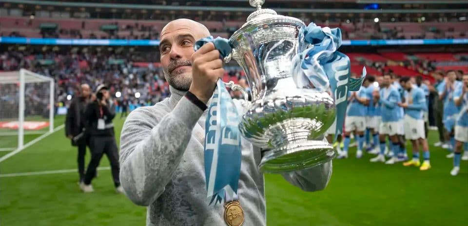 Manager holding trophy after winning match at Wembley Manager holding trophy after winning match at Wembley