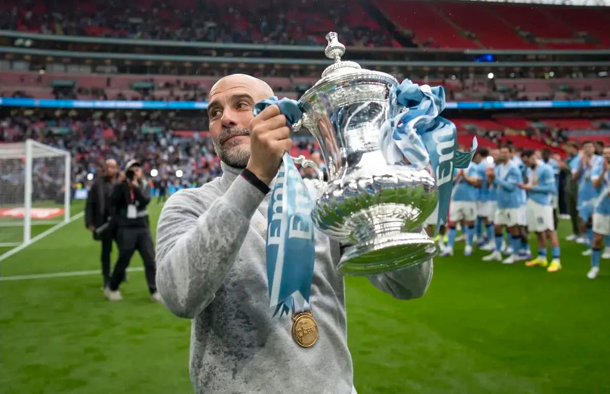 Manager holding trophy after winning match at Wembley Manager holding trophy after winning match at Wembley