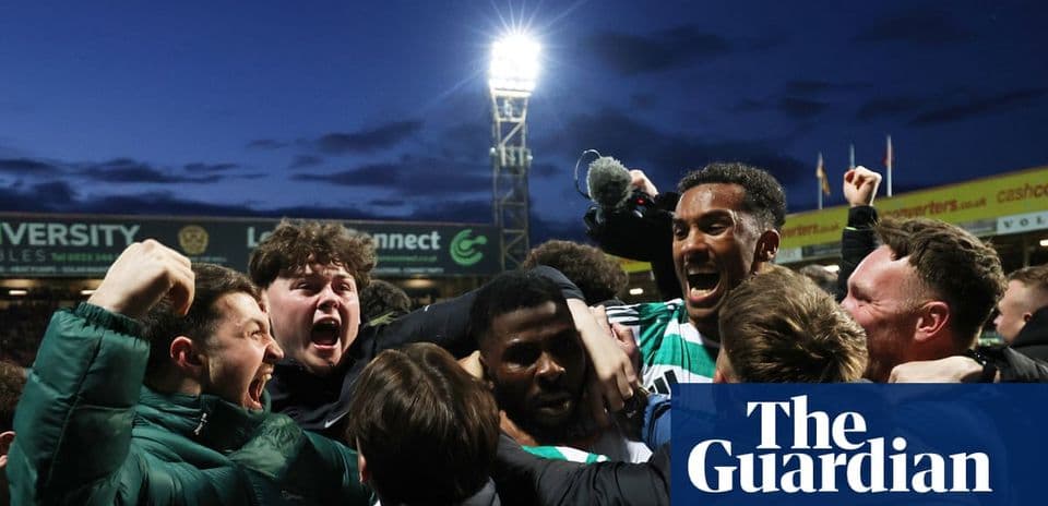Fans celebrating a goal at a football match Fans celebrating a goal at a football match