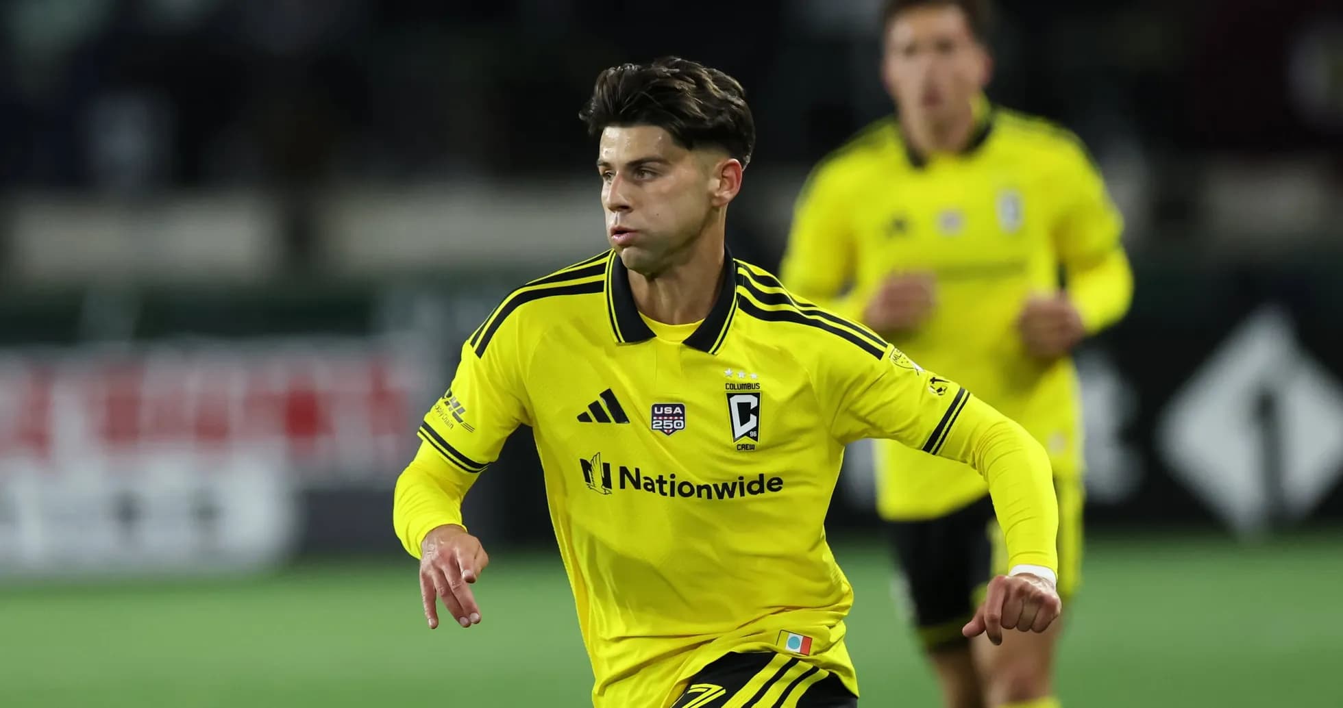 Columbus Crew player in yellow jersey running Columbus Crew player in yellow jersey running