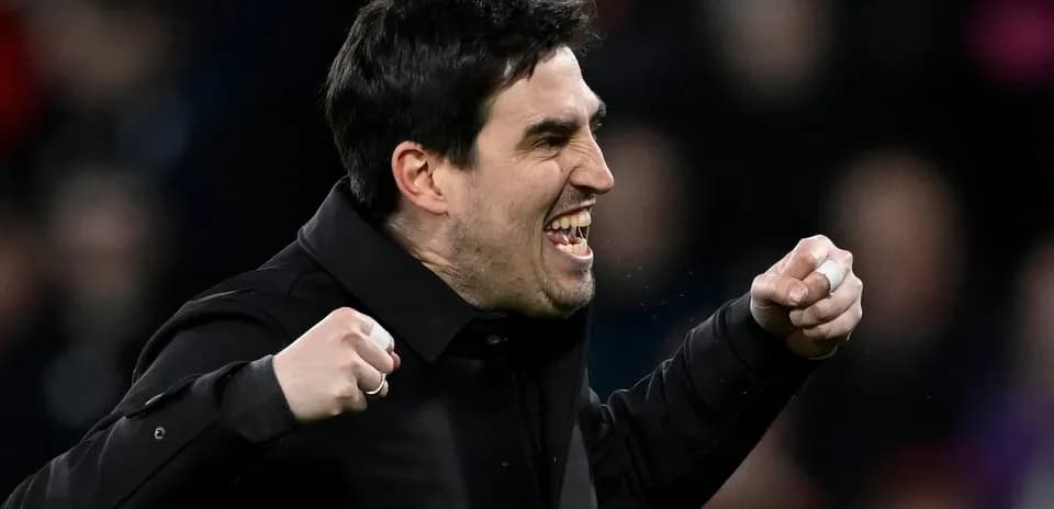 Coach celebrating with clenched fists on sidelines Coach celebrating with clenched fists on sidelines