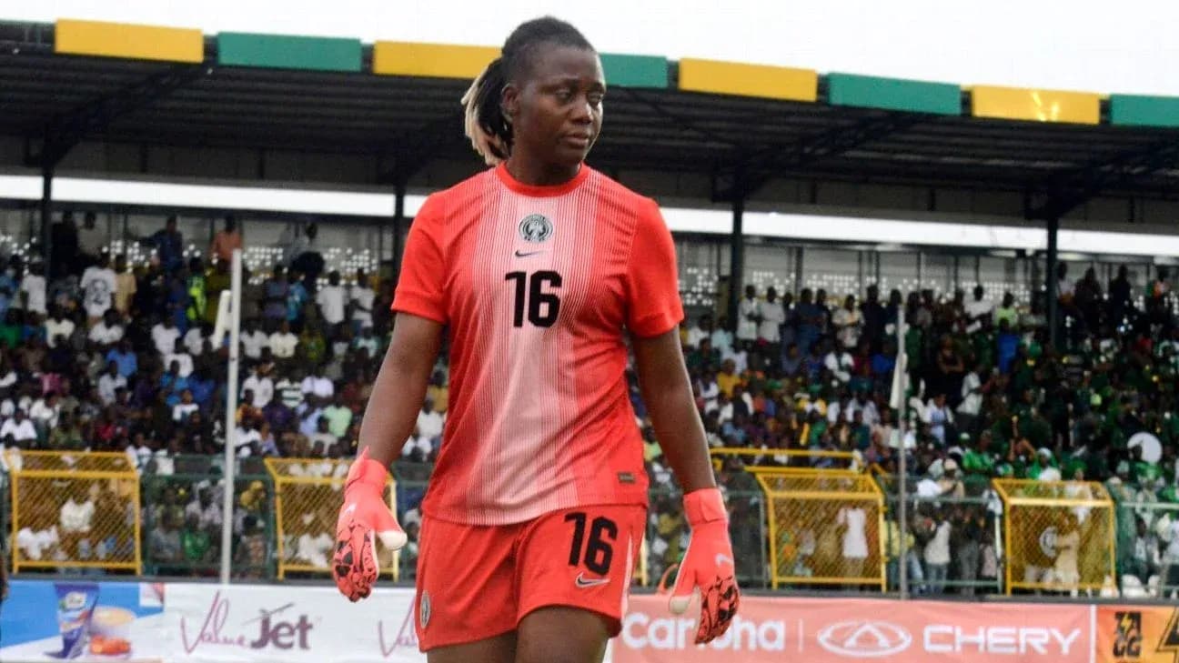 Goalkeeper in red kit walking on the field Goalkeeper in red kit walking on the field