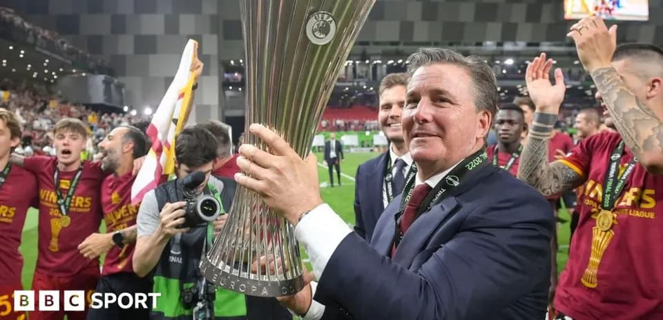Manager celebrating with UEFA Europa League trophy Manager celebrating with UEFA Europa League trophy