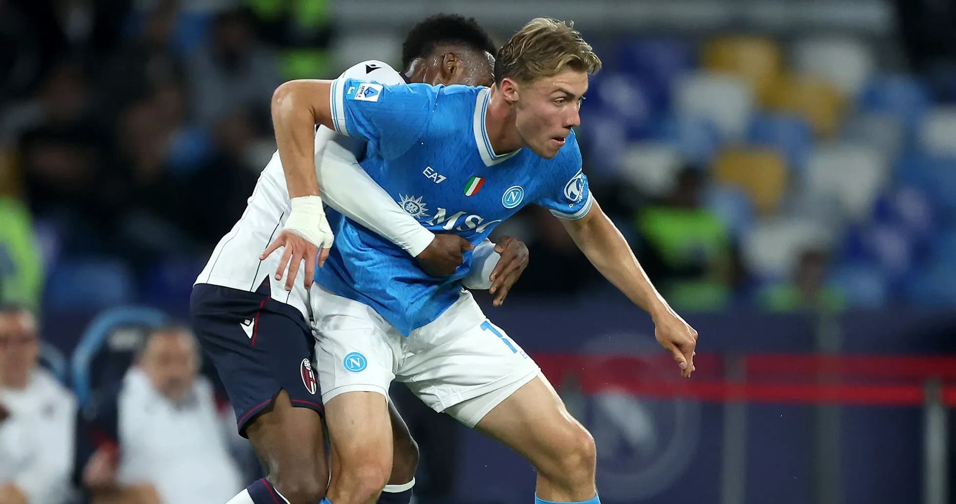 Player from Napoli evading opponent's tackle during match Player from Napoli evading opponent's tackle during match
