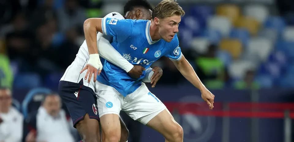 Player from Napoli evading opponent's tackle during match Player from Napoli evading opponent's tackle during match