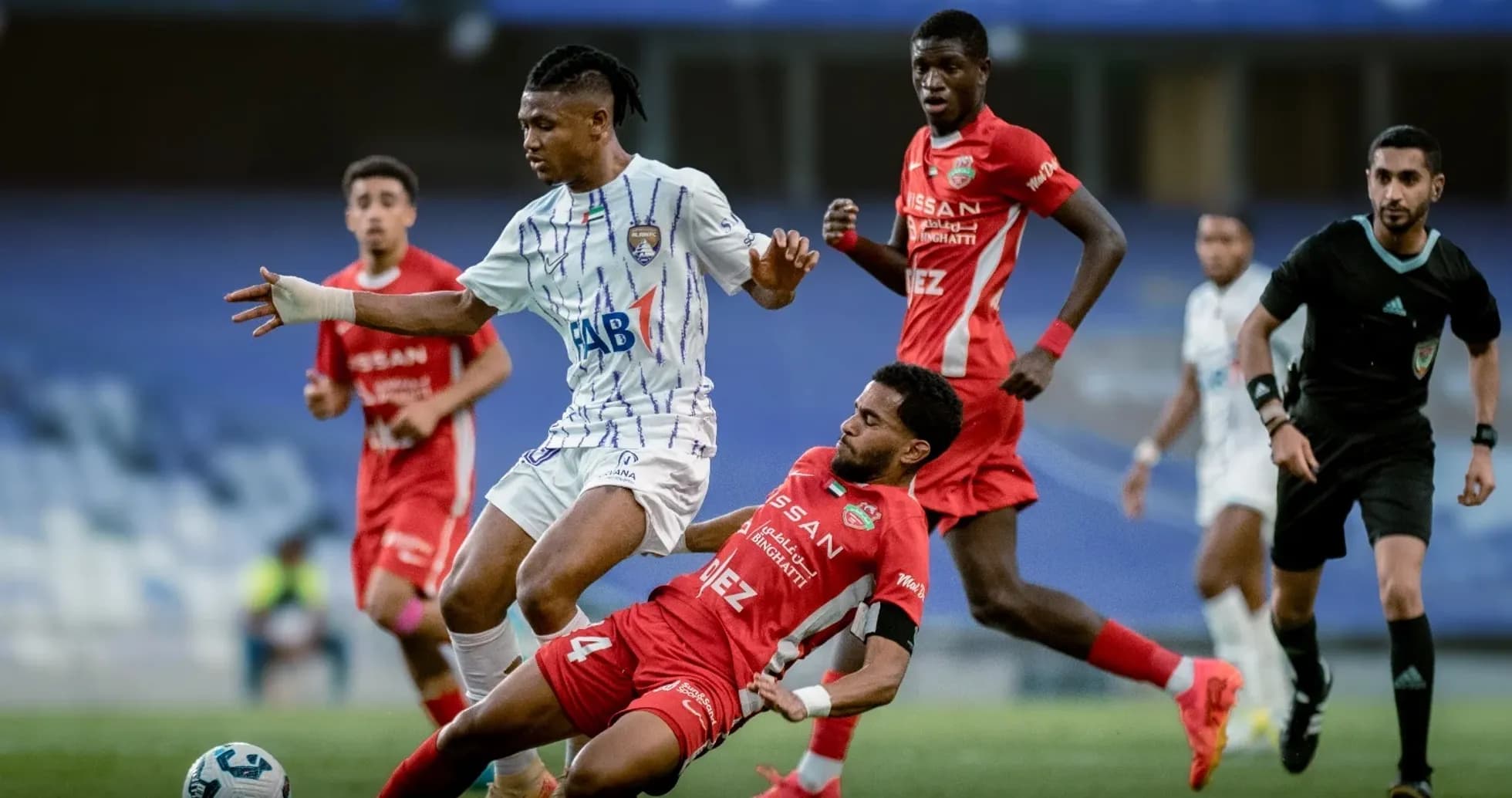 Al Ain U23 player dribbling past Al Sharjah U23 opponent Al Ain U23 player dribbling past Al Sharjah U23 opponent