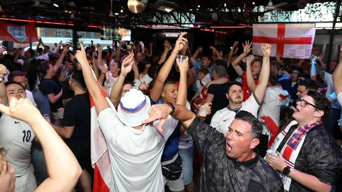 Crowd of fans celebrating in bar with drinks Crowd of fans celebrating in bar with drinks