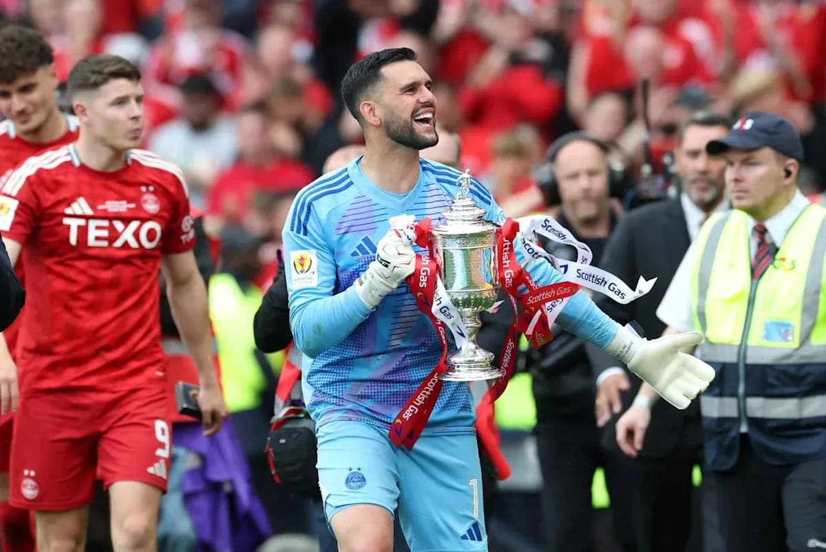 Goalkeeper celebrating with trophy after match Goalkeeper celebrating with trophy after match
