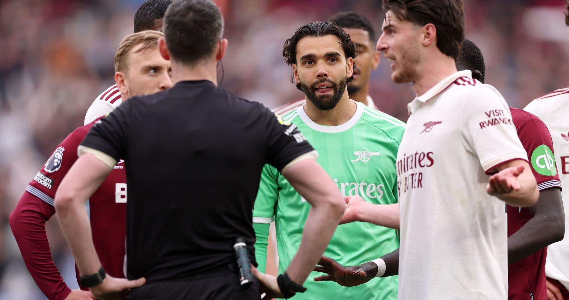 Players discussing with referee during match confrontation Players discussing with referee during match confrontation