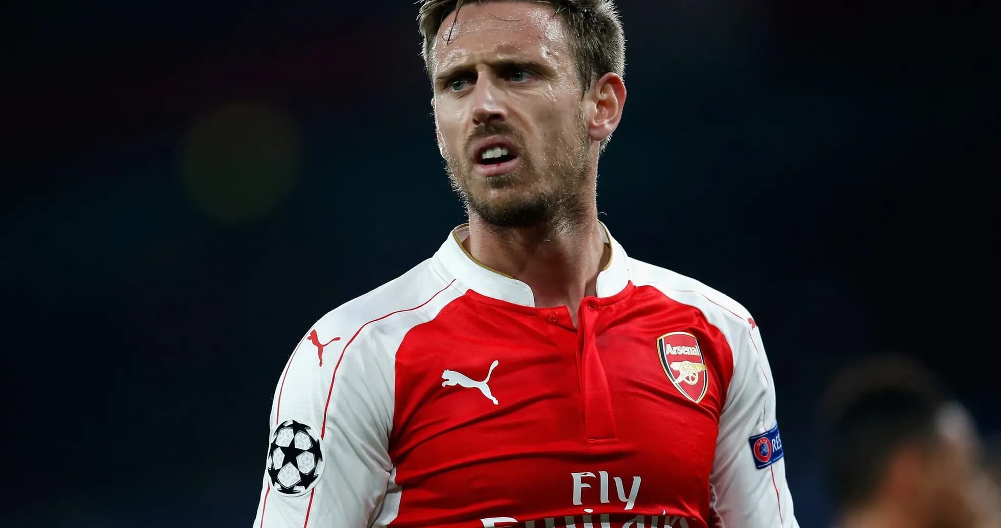 Player in Arsenal jersey during a match Player in Arsenal jersey during a match